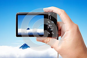 Tourist's hand holding photo camera