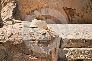 Tourist`s hat on rang of old stone wall of Santa Barbara castle