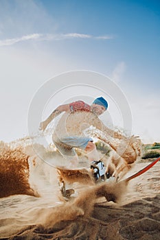 Tourist Sandboarding In the Desert Man jumps in and does the trick