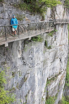 Tourist at scary footpath around cliffs in Tianmen mountain, China