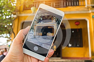 Tourist Selfie photo of yellow old house at Walking on streets of Hoi An, Hoi An is culture, heritage UNESCO World Heritage Site