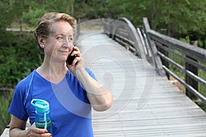 Tourist senior woman using cell smart phone call smile summer vacation green tree park travel communication