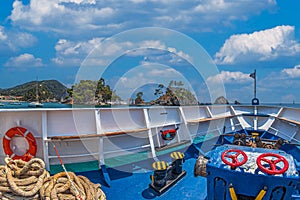 Tourist ship with colorful navigation tools near Island of Panagia, Parga harbor, Greece