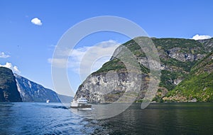 A tourist ship and cruise liner are sailing on the Sognefjord, Norway