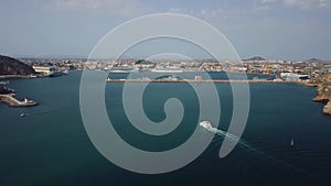 Tourist ship entering the port of Cartagena, Spain, on a sunny day, great general shot of the city and the entire port, we see two