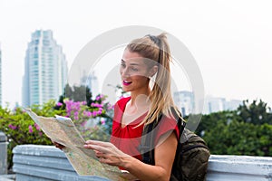 Tourist sightseeing with city map in Indonesia