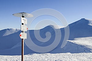 Tourist sign inscription - Gendarme, Dragobrat, Bliznitsa - on the snow-covered Svydovets mountains