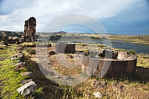 Tourist at the Silustani tombs in the peruvian Andes at Puno Peru