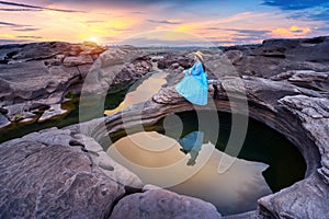 Tourist sitting at Sam Phan Bok in Ubon ratchathani, Thailand. Grand canyon of Thailand