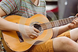 Tourist sitting in the tent, play the guitar and sing songs