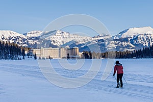 Tourist skating on Lake Louise winter trail. Banff National Park