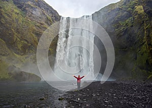 Tourist at SkÃÂ³gafoss waterfall