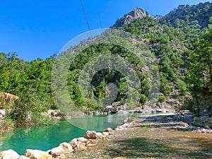 Tourist sliding on a zip line in the canyon of Harmony, near the town of Goynuk and Antalya