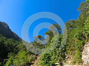 Tourist sliding on a zip line in the canyon of Harmony, near the town of Goynuk and Antalya