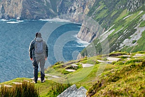 Tourist at Slieve League, Irelands highest sea cliffs, located in south west Donegal along this magnificent costal driving route.