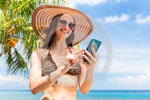 Tourist with smart phone on beach needs data roaming