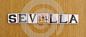 Tourist souvenir from Seville. Signboard in relief tiles