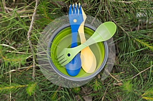 Tourist spoons in a plate. The beginning of dinner.