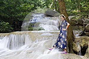 Touris stand look waterfall  at Erawan Waterfall and  natural photo