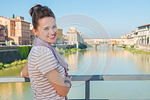 Tourist standing on the bridge overlooking Ponte Vecchio