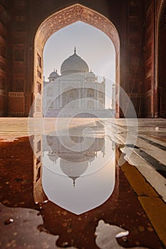 tourist standing in front entrance gate of Taj Mahal indian palace. Islam architecture. Door to the mosque