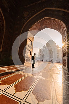 tourist standing in front entrance gate of Taj Mahal indian palace. Islam architecture. Door to the mosque