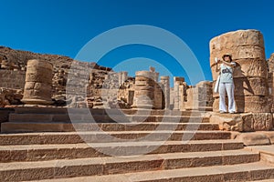 Tourist standing roman temple in Nabatean city of photo