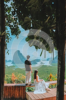 Tourist summer vacation concept. Couple enjoying a vacation in a beautiful view cafe in Phang Nga, Thailand