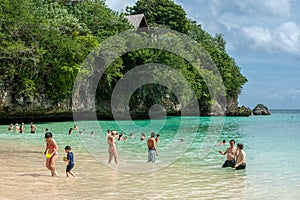 Tourist swimming at a private beach in Bali