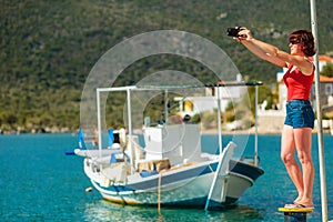 Tourist take photo in greek marina