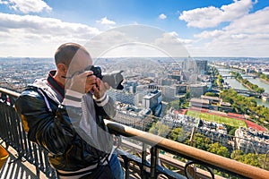 Tourist take picture of Paris from the Eiffel Tower
