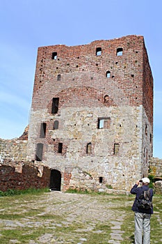 Tourist takes a photo of the Hammershus rÃ¼in