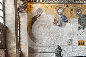 Tourist takes photo of Jesus Christ Pantocrator,Detail from deesis Byzantine mosaic in Hagia Sophia in Istanbul, Turkey,March,11