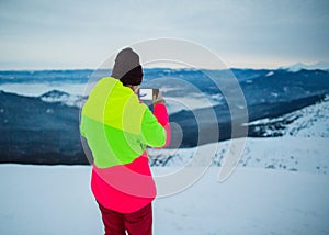 Tourist takes a photo on the mountainside