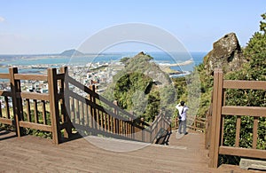 Tourist takes photo view from Seongsan Ilchulbong in Jeju Island, South Korea