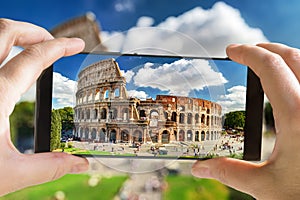 Tourist taking photo of the Ancient Roman Colosseum, Rome, Italy