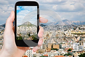 Tourist taking photo of Athens city skyline