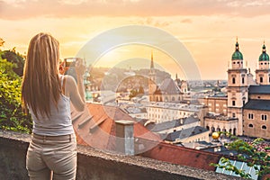 Tourist taking a photo of beatiful sunset in Salzburg Austria