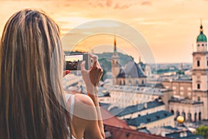 Tourist taking a photo of beatiful sunset in Salzburg Austria
