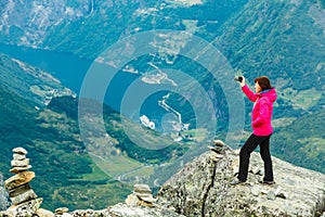 Tourist taking photo from Dalsnibba viewpoint Norway