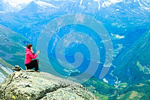 Tourist taking photo from Dalsnibba viewpoint Norway