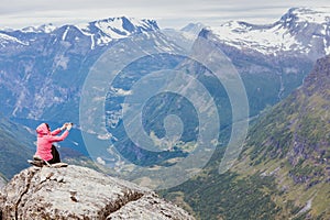 Tourist taking photo from Dalsnibba viewpoint Norway