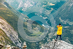 Tourist taking photo from Dalsnibba viewpoint Norway