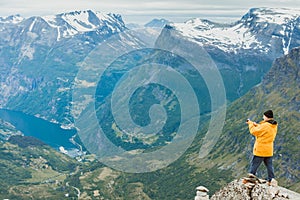 Tourist taking photo from Dalsnibba viewpoint Norway