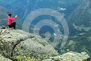 Tourist taking photo from Dalsnibba viewpoint Norway