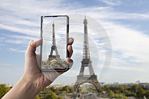 Tourist taking photo of Eiffel tower in Paris, France