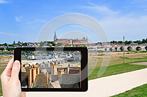 Tourist taking photo of Gien town, France