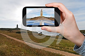 Tourist taking photo of lighthouse Tower of Hercules