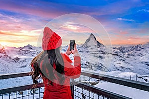 Tourist taking photo at Matterhorn and swiss alps in Zermatt, Switzerland