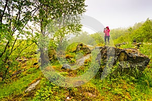 Tourist taking photo in mountains Norway